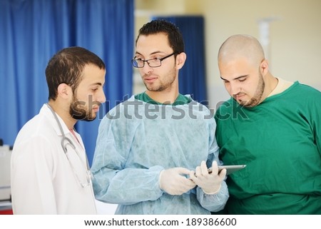 Teamwork of doctors working with tablet pc at hospital for discussion