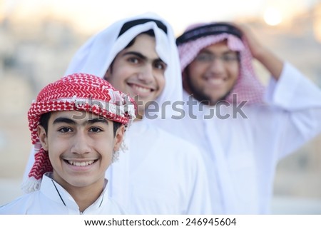 Group of Arabic boys standing in line and pointing