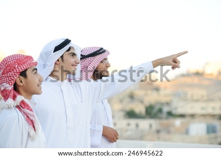 Group of Arabic boys standing in line and pointing