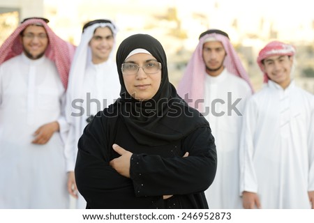 Arabic Muslim businesswoman leading group of Middle eastern Gulf people