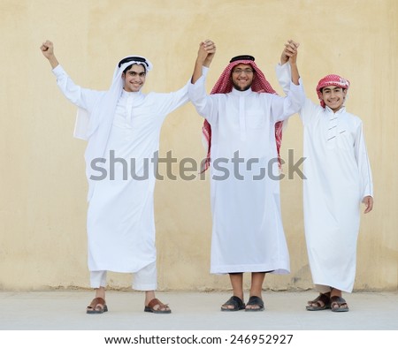 Group of young Arabic Gulf people dancing and celebrating eid party