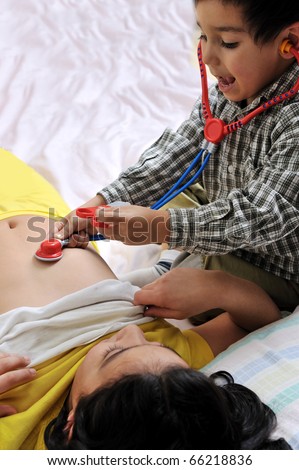 girl & boy playing with doctor's stethoscope toy