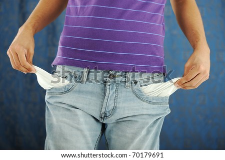 close-up of the hand of a man showing the pocket of his pants empty