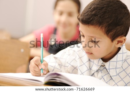 school boy is writing