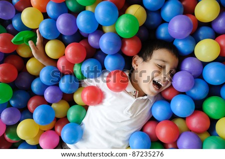 Kid, colors, ball - playing in many colorful balls