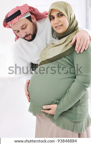 Portrait of a happy young pregnant muslim woman with her husband