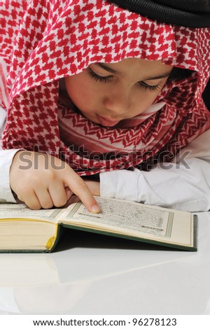 Muslim boy reading Koran