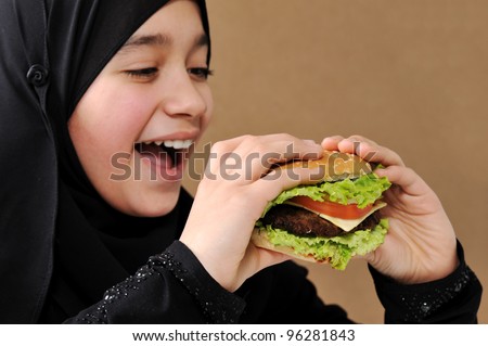 stock photo Arabic girl eating burger Save to a lightbox 