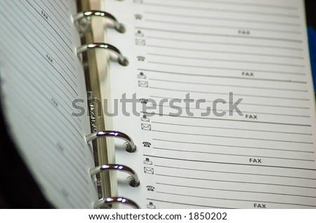 Notebook opened on page of contacts, shallow DoF.