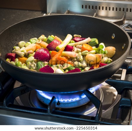 Winter vegetables in wok on stove