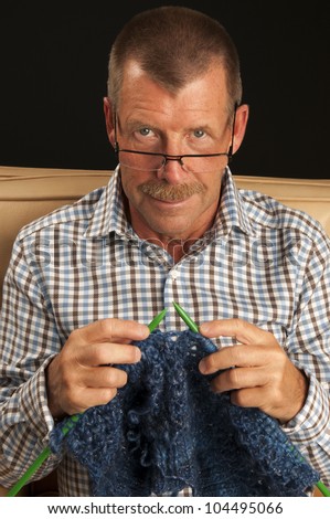 A man is active with his hobby knitting.