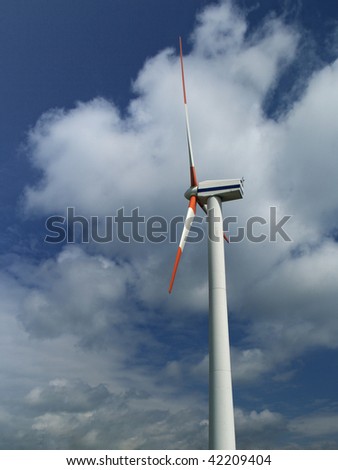 Electric wind generator under nice clouds in sky