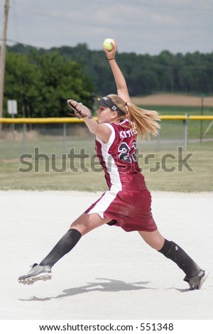 Teenage girl playing softball.