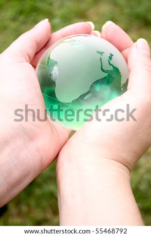 glass ball in the hands of the planet