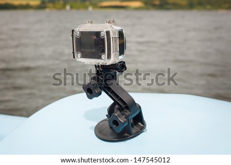 Extreme camera with a suction cup holder on a boat.