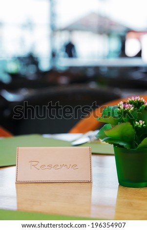 Light brown leather Reserved Sign on o restaurant table