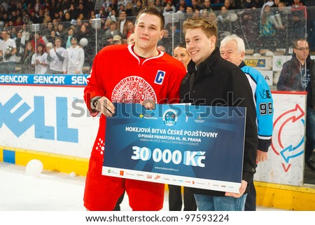 PRAGUE, CZECH REPUBLIC - MAY 7: Captain Roman Alexa takes the prize money 30000czk after final match of university league between of Charles University (red) and VSE (white) on May 7, 2012 in Prague, Czech Republic.