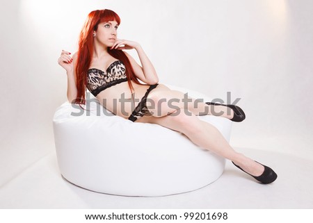 Gorgeous young redhead relaxing on a large white pillow in the studio. Check also my other pictures with the model!