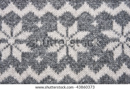 Knitting texture with white and grey ornament.