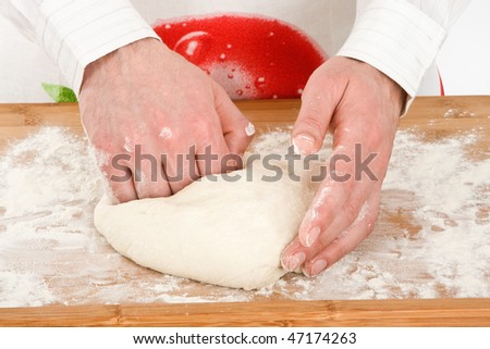 Male chef kneading dough for baking.
