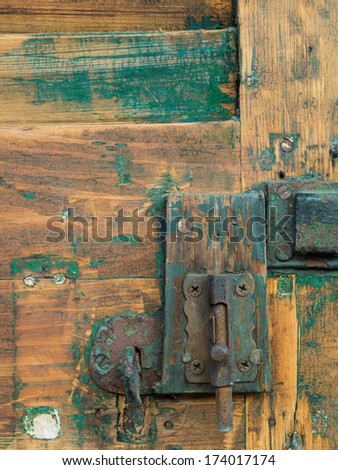 Detail of old wooden door with fading paint in French Quarter, New Orleans.