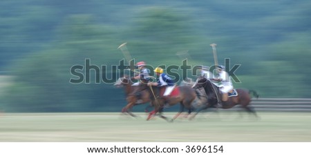 Polo Match at full gallop with intentional panning blur to emphasize speed