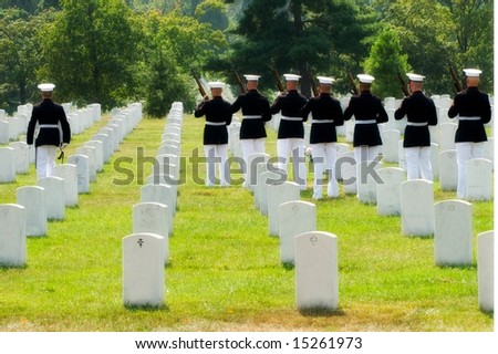 Horizontal photo of military honor guard preparing to fire final salute at funeral at Arlington National Cemetery
