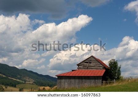 Large wooden barn on Virginia farm with Blue Ridge Mountains in background