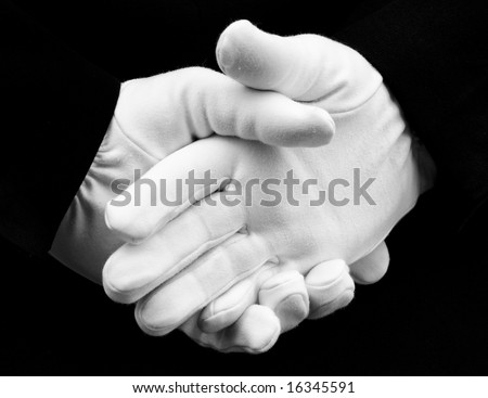 Hands with white gloves being clasped behind back in \
