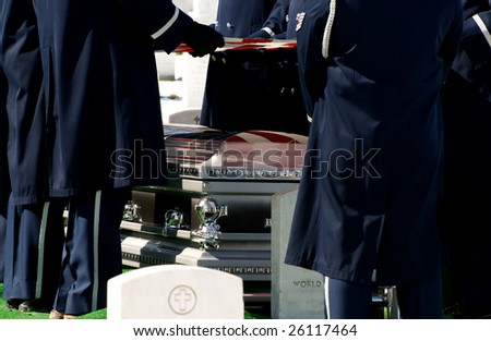 Casket at military funeral at Arlington National Cemetery with American flag reflected on casket