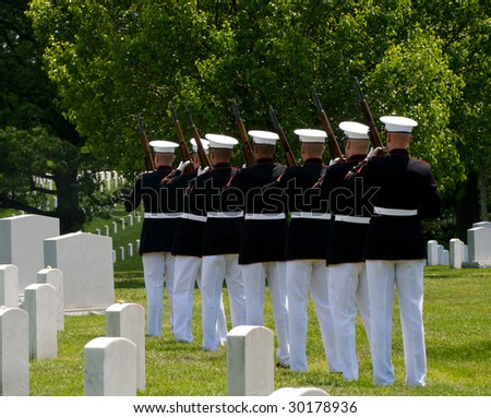 Arlington National Cemetery with military Honor Guard preparing to fire a final salute