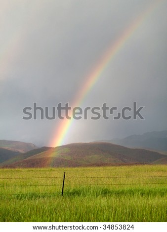 End of summer rainstorm on the front range of the Colorado Rockies with rainbow