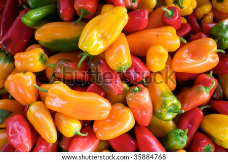 Horizontal photo of large group of colorful hot, spicy peppers at local food market