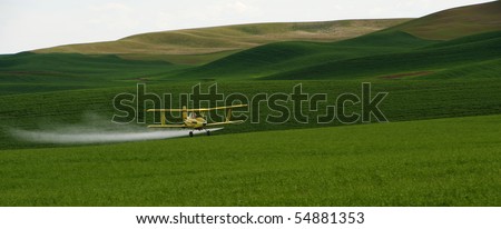 Crop dusting airplane applying Pesticide to the wheat fields of the Palouse