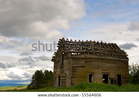 Old abandoned wooden farm house in advanced state of decay in the Palouse region of Washington state in the US