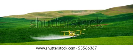 Crop dusting airplane spraying pesticide on wheat fields in the Palousezf