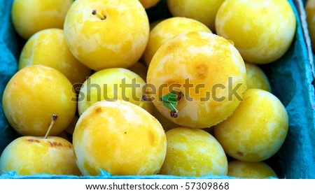 Large group of yellow plums at farm market
