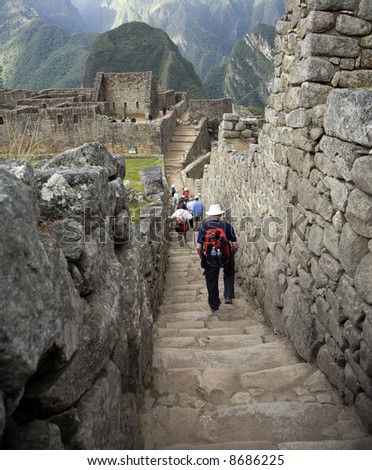 Tourists Walking Down Path at Machu Picchu Eighth Wonder of World