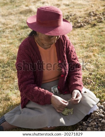 PERU - AUGUST 2: A native Peruvian woman demonstrates how to eat Coca Leaves August 2, 2007 in Sacred Valley, Peru.