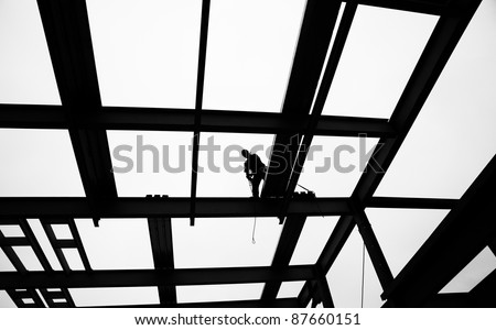 Dramatic Stylized Black and White of Silhouette of Steel Workers and Crane at Construction Site