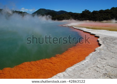Smoke over the bubbling hot water of a colorful geothermal pool called the Champagne Pool at Rotorua, North Island, New Zealand