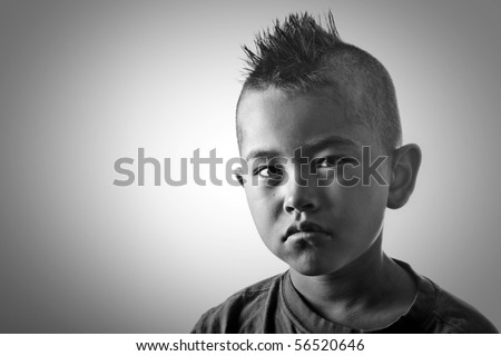 Young boy with funny mohawk haircut and serious look in black and ... Young boy with funny mohawk haircut and serious look in black and ...