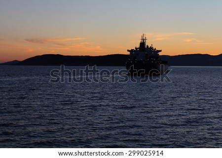 Silhouette of the sea ship against a sunset. Adriatic sea.