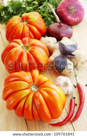 Large tomatoes with spices, vegetable still life