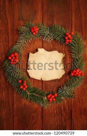 Christmas wreath of fir branches on the wooden background