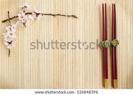 flowering apricot and Chinese sticks on a bamboo stand