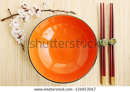 flowering apricot and Chinese sticks on a bamboo stand