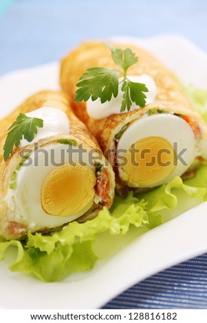 pancake stuffed with egg and salmon with sour cream