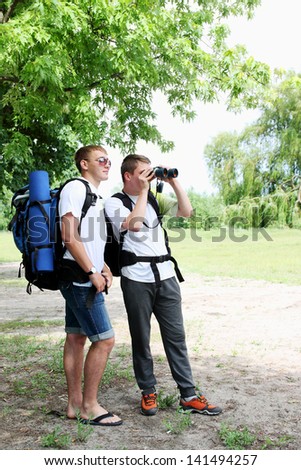 A group of young backpackers with map and binoculars
