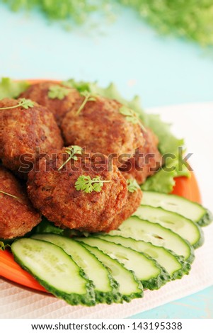 Fried cutlets with cucumber and watercress salad